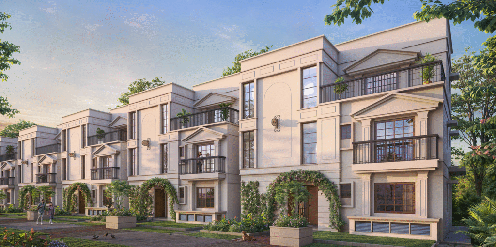 Elegant 3-storey European-style luxury villas with balconies, arched entryways, and lush landscaping at NVT Oikos in Whitefield, Bangalore.
