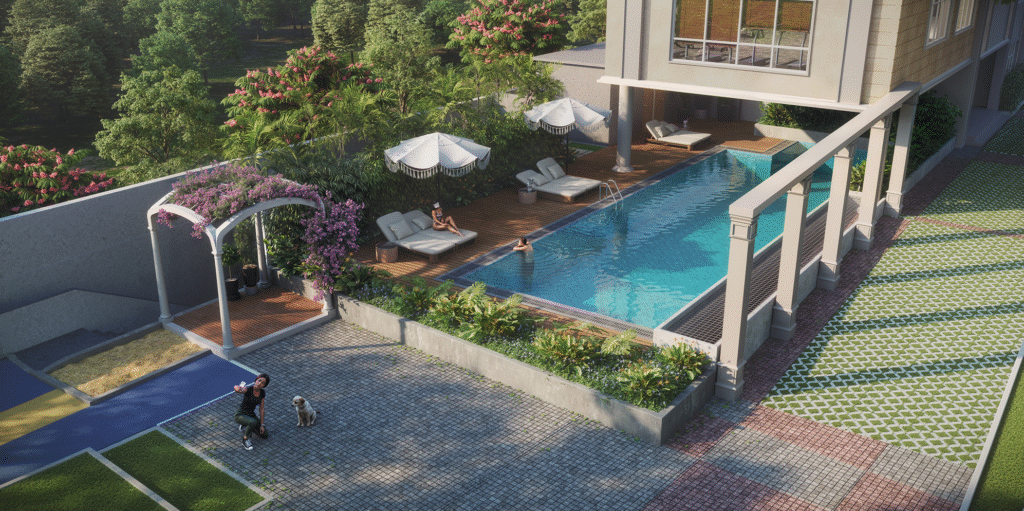 Luxurious swimming pool area with lounge chairs, umbrellas, and lush greenery at NVT Oikos in Whitefield, Bangalore, with residents relaxing poolside.
